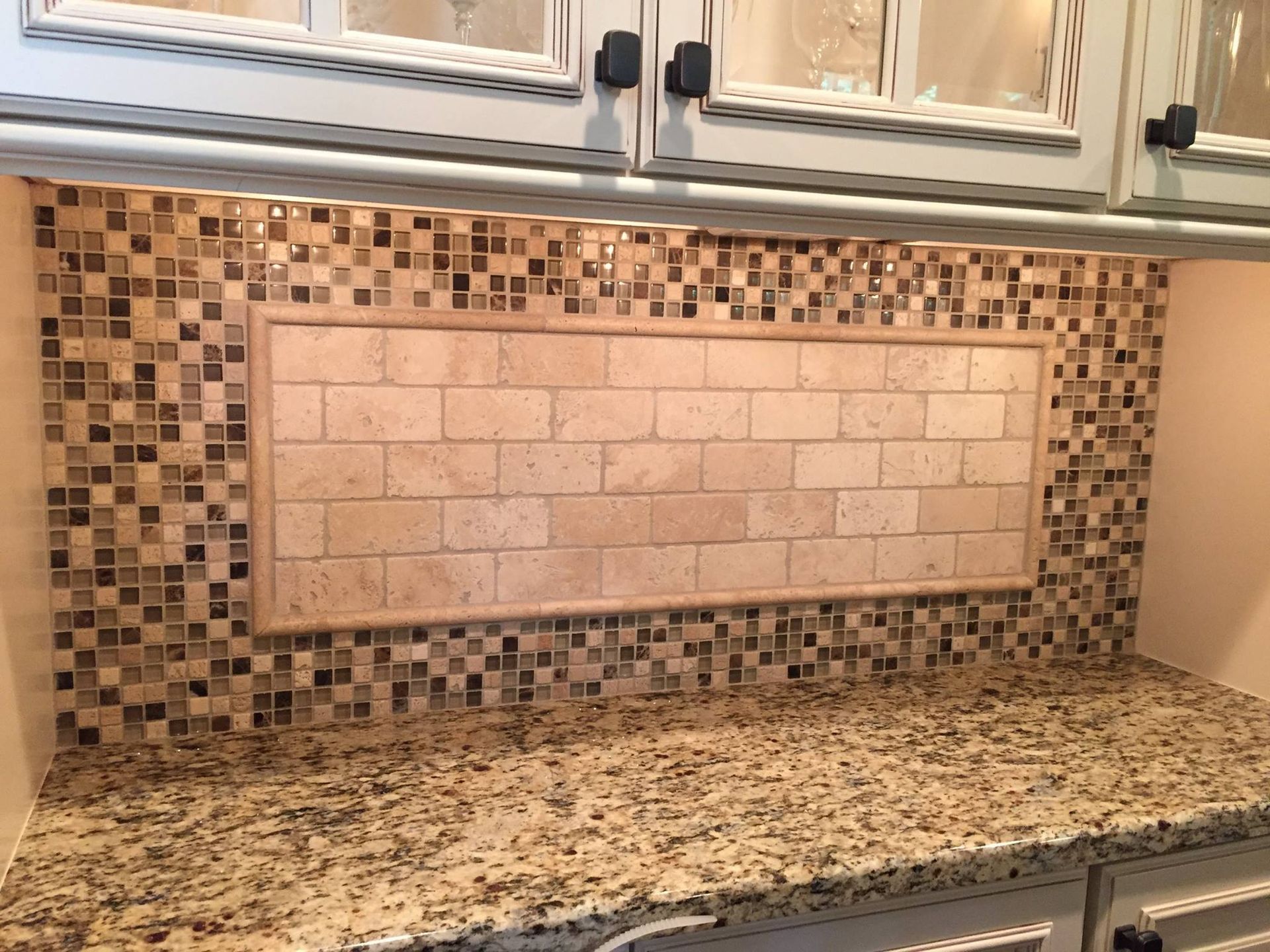 A kitchen counter with a brick wall behind it