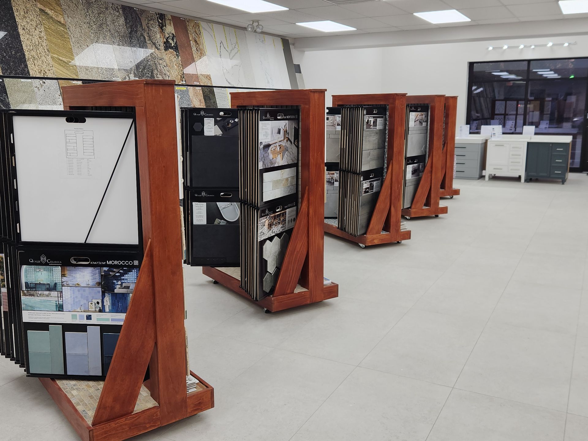 Tile showroom interior with brown wooden display stands holding tile samples