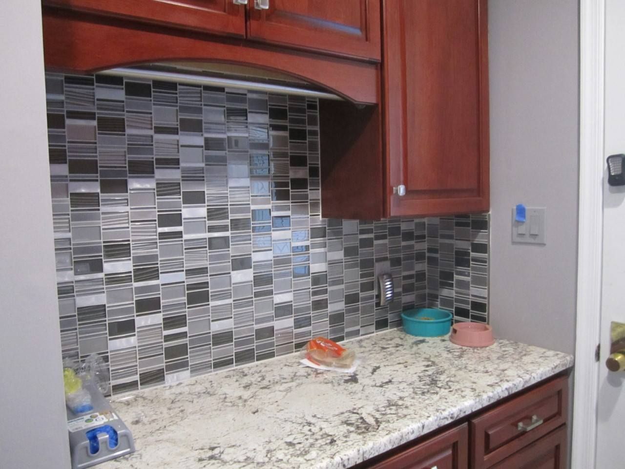 A kitchen with granite counter tops and wooden cabinets