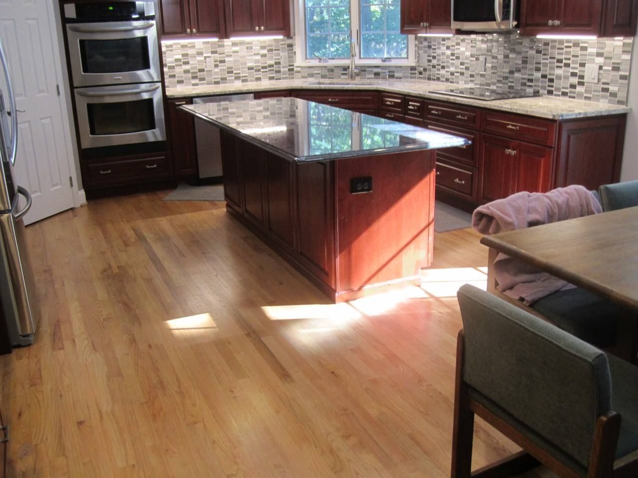 A kitchen with a large island in the middle