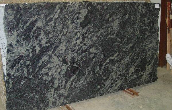 A large piece of granite is sitting on the floor.