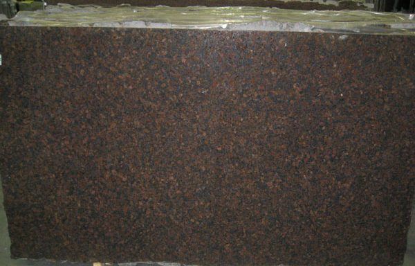 A large piece of brown granite is sitting on top of a table.