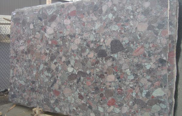 A large piece of granite is sitting on top of a wooden table.