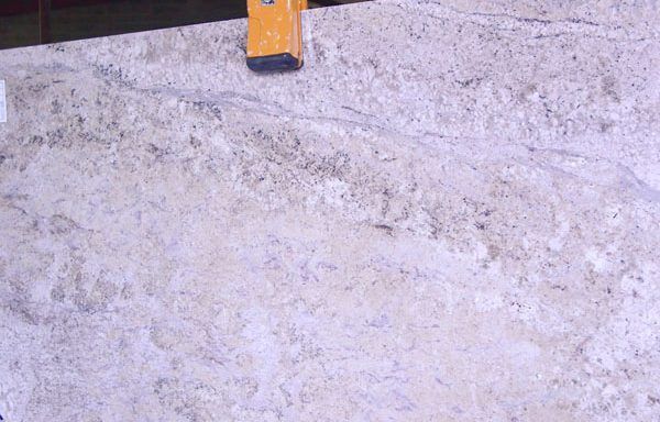 A yellow level is sitting on top of a concrete surface.