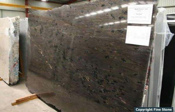 A large slab of granite is sitting in a warehouse