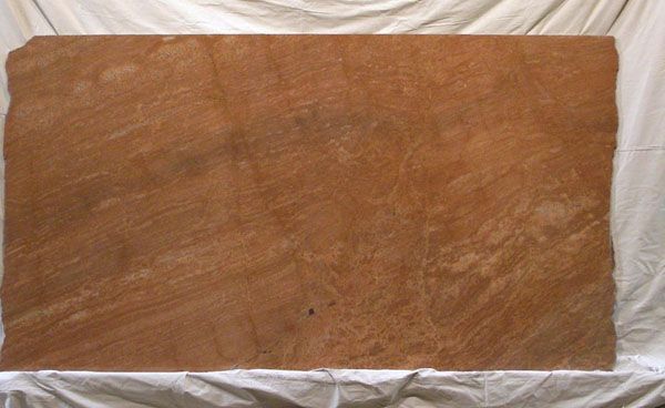 A large piece of wood is sitting on a white cloth.