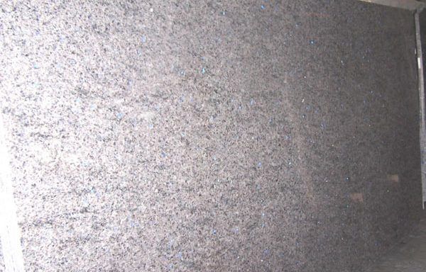 A close up of a gray granite counter top.