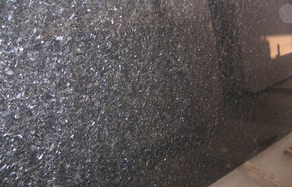 A close up of a black granite counter top