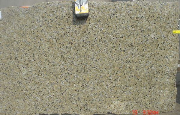 A close up of a granite slab with a measuring tape on it