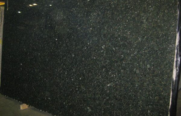A large black granite slab is sitting on a table.
