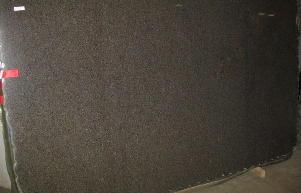 A large piece of black granite is sitting on a table.