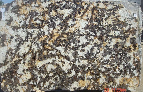 A piece of rock with a lot of different colored stones on it