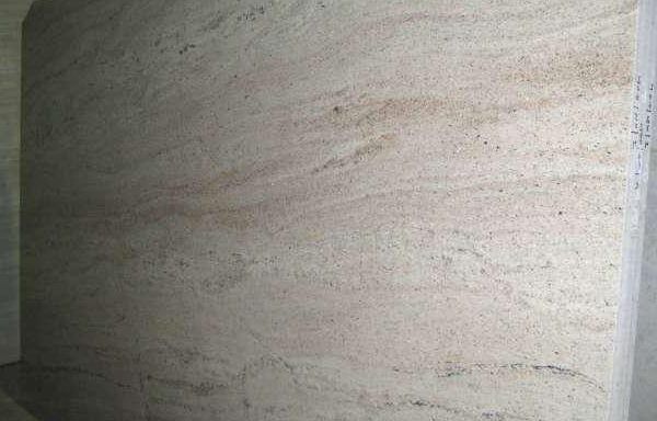 A close up of a white marble slab on a wall.