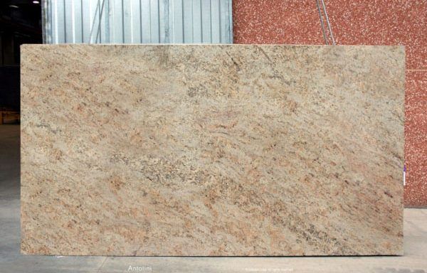A large slab of granite is sitting in front of a building.