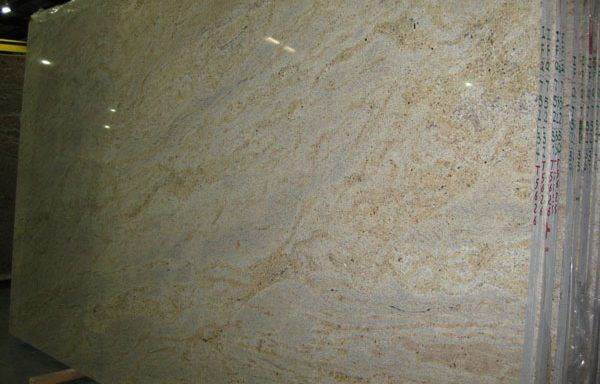 A large white granite slab is sitting on top of a wooden table.
