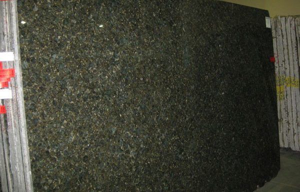 A large green granite slab is stacked on top of each other