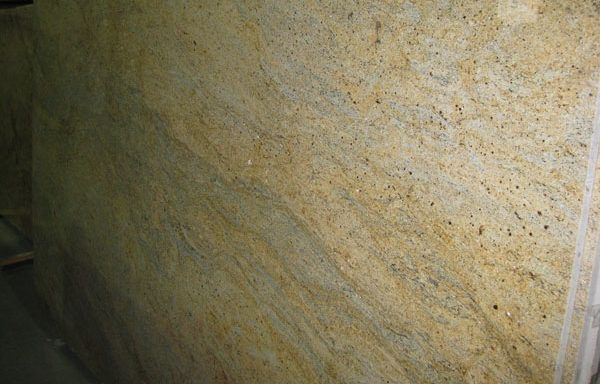 A large piece of granite is sitting on the ground in a room.