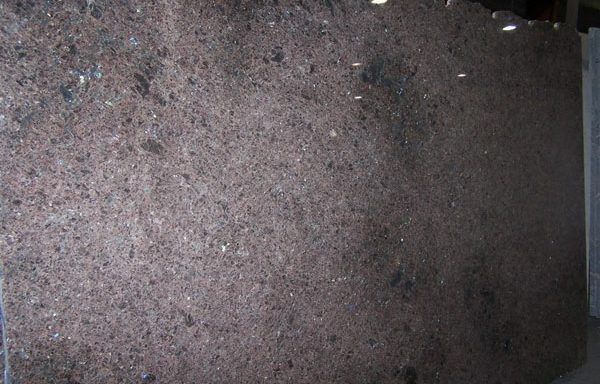 A large brown granite slab is sitting on a table.
