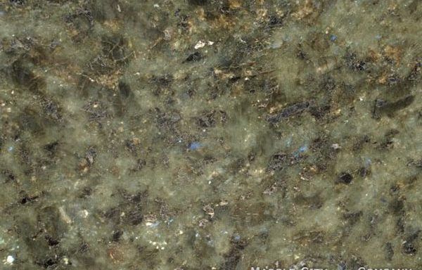 A close up of a green granite counter top.