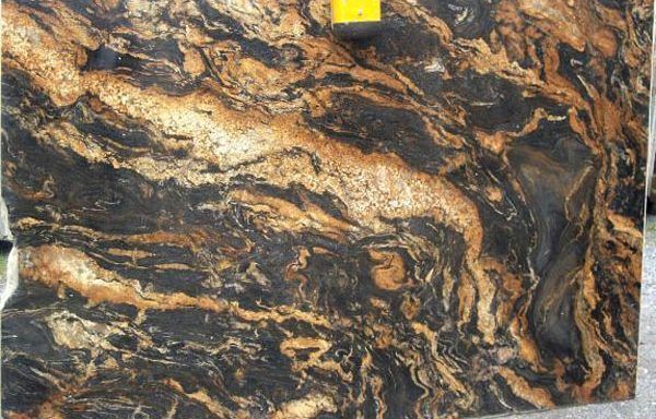 A close up of a black and gold granite slab.