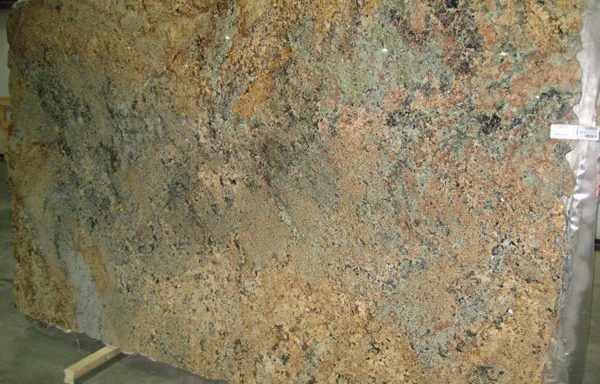 A large piece of granite is sitting on top of a wooden stand.