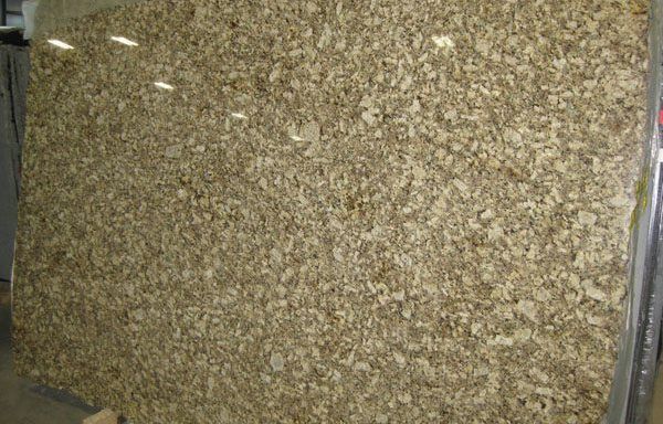 A large piece of granite is sitting on top of a wooden table.