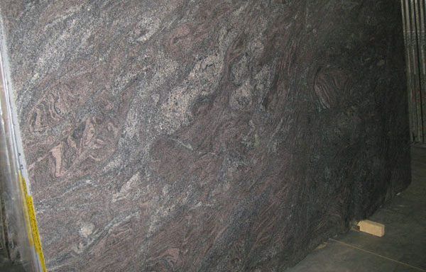 A large piece of granite is sitting on the floor in a room.