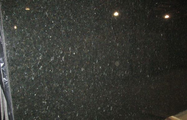 A close up of a black granite counter top.