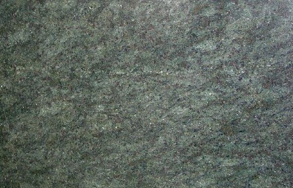 A close up of a green granite counter top.