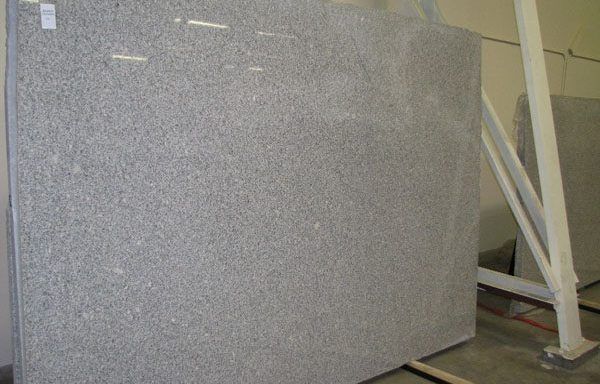 A large gray granite slab is sitting on top of a wooden table.