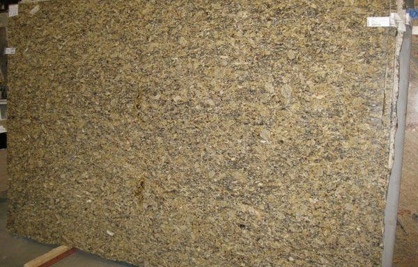 A large piece of granite is sitting on top of a wooden table.