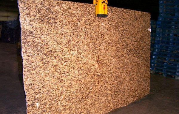 A large piece of plywood is being lifted by a crane.