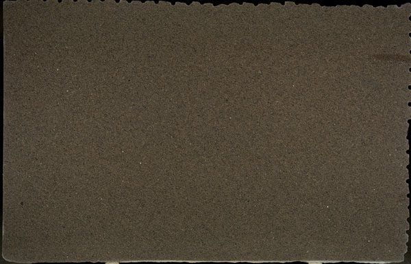 A close up of a piece of brown paper on a black background.