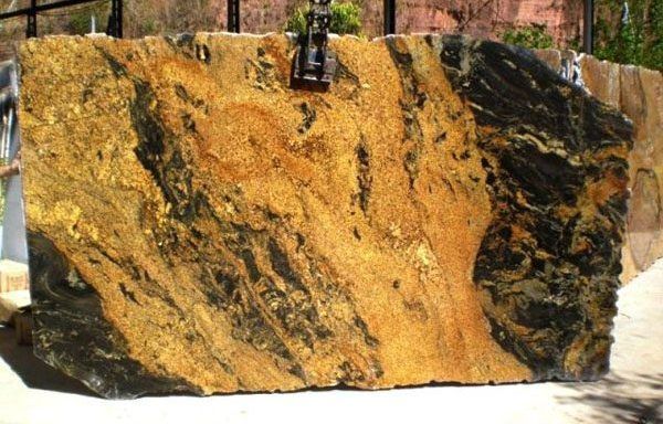 A large piece of granite is sitting on top of a white surface.