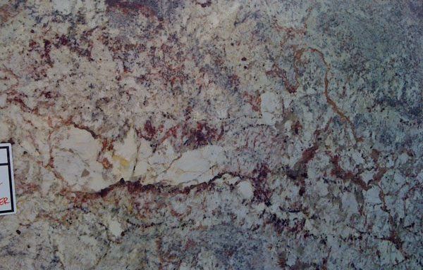 A close up of a piece of granite with a label on it.