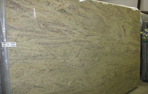 A large slab of granite is wrapped in plastic.