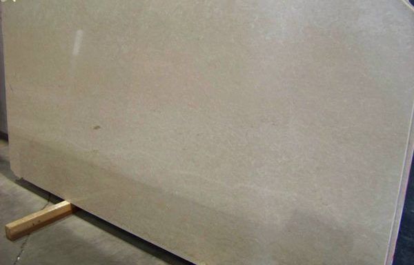 A large piece of marble is sitting on a wooden stand.