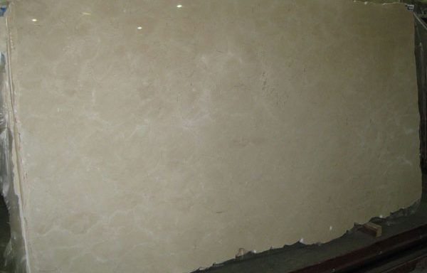 A large piece of white marble is sitting on top of a wooden table.