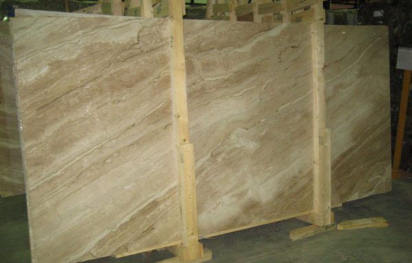 A large piece of marble is sitting on top of a wooden stand.