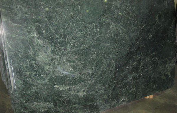 A green marble slab is sitting on a table.