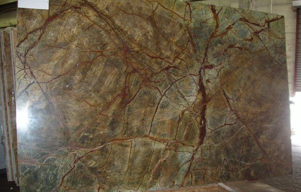 A large piece of marble with a tree shaped pattern is sitting on a table.