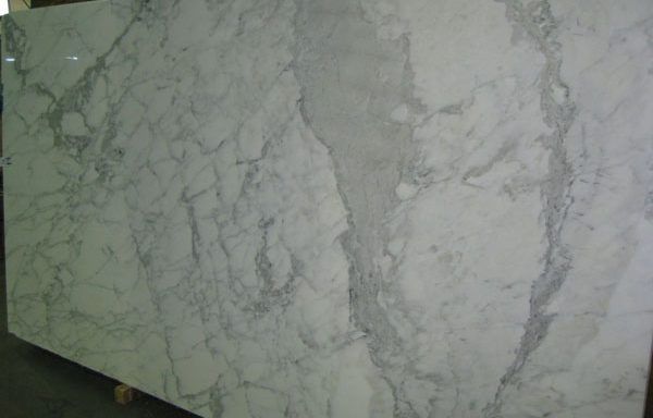 A large white marble slab is sitting on top of a wooden table.