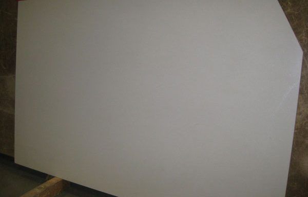 A white piece of paper is sitting on top of a wooden table.