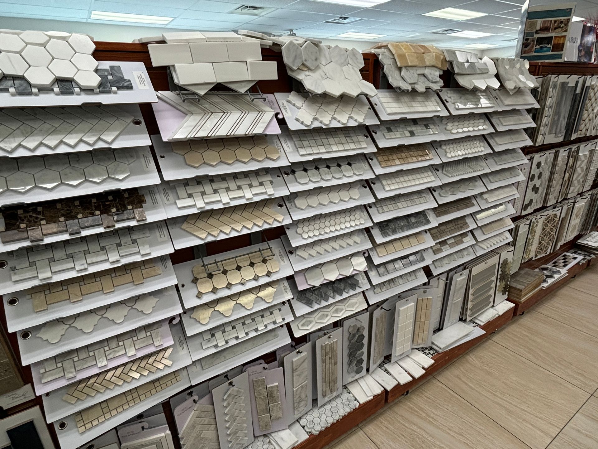 There are many different types of tiles on the shelves in this store.