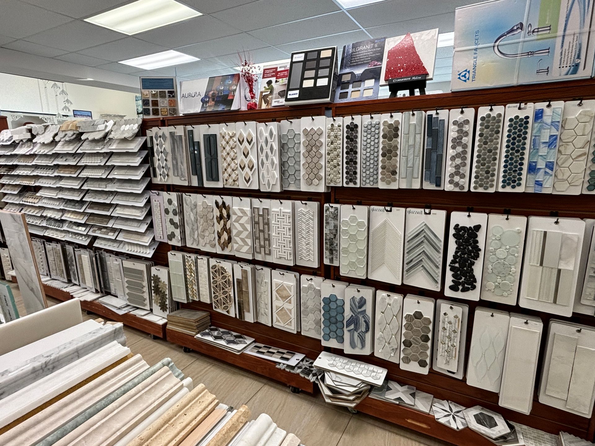 There are many different types of tiles on the shelves in this store.
