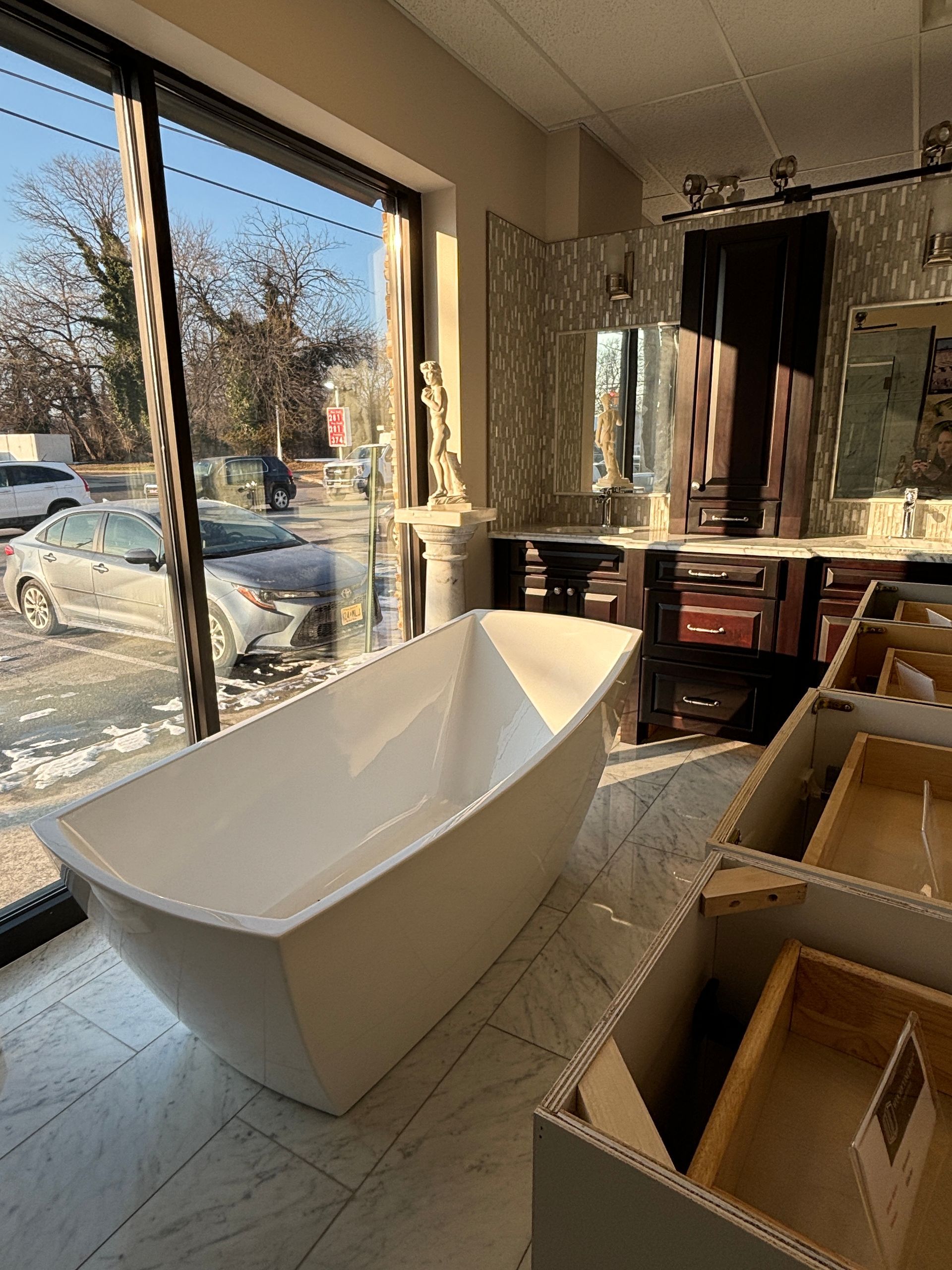 A bathtub is sitting in a bathroom next to a window.