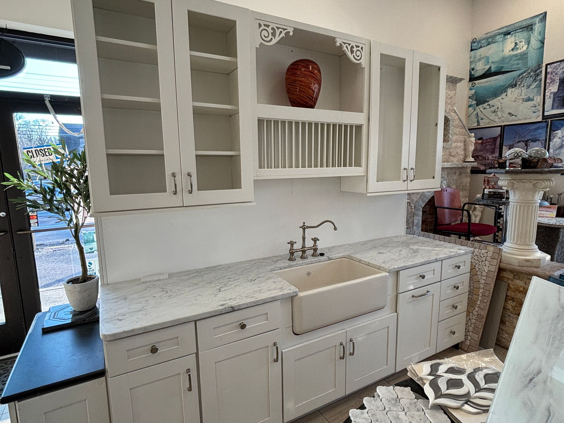 A kitchen with white cabinets , granite counter tops , and a sink.