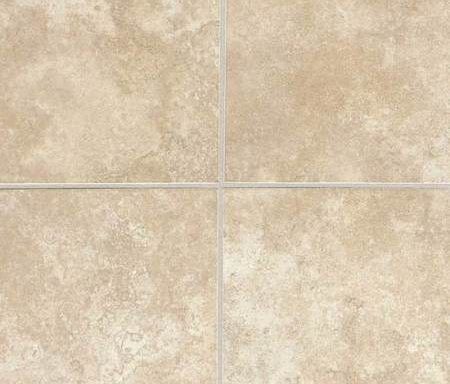 A close up of a tile floor with a white grout.