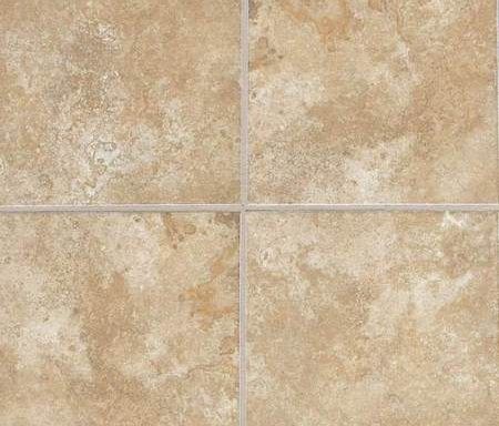 A close up of a tile floor with a white grout.