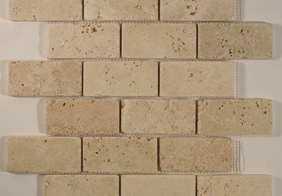 A close up of a brick wall made of tiles on a white surface.